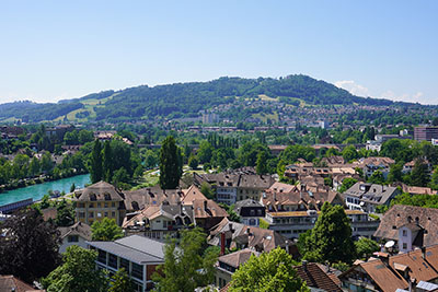 Bern rooftops, river, and tree-covered hilltops