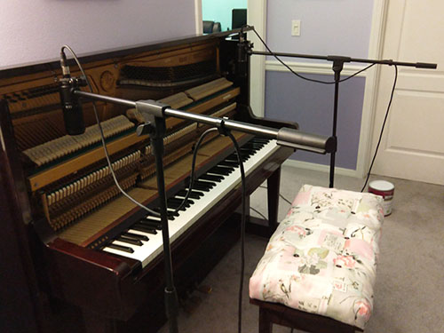 Photo of piano recording setup with boom mics